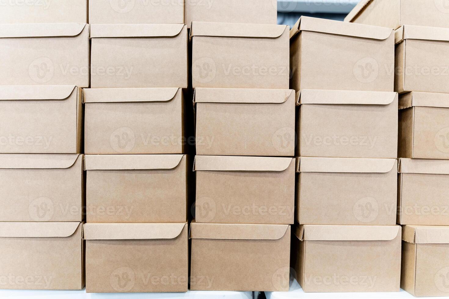 A large stack of cardboard boxes in a warehouse photo
