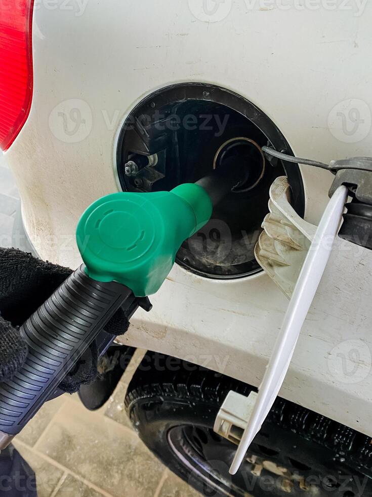 Refueling your vehicle at a gas station that features a green nozzle is a great way to choose ecofriendly options, thereby promoting sustainable energy practices effectively photo