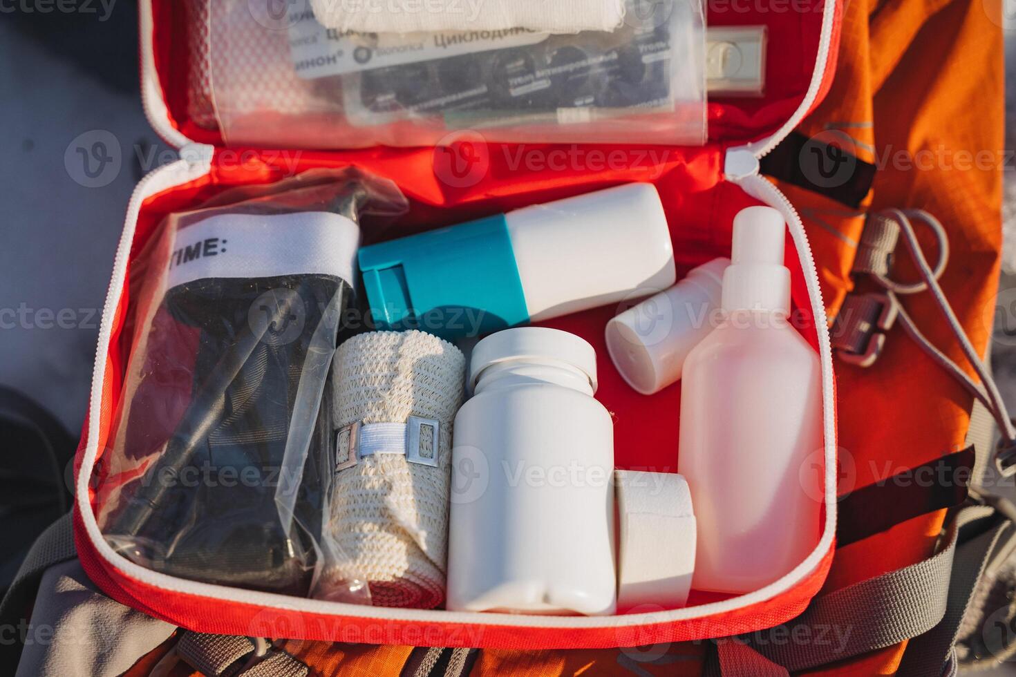 An individual is carrying a meticulously organized first aid kit inside their backpack for added convenience while traveling or engaging in outdoor activities and adventures photo