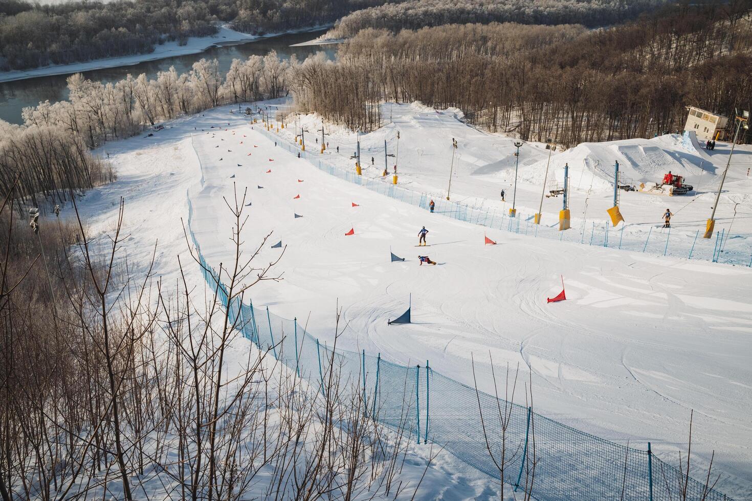 A group of enthusiastic individuals skillfully skiing down a pristine, snowcovered slope that glistens under the winter sun, enjoying the exhilarating experience of winter recreation photo
