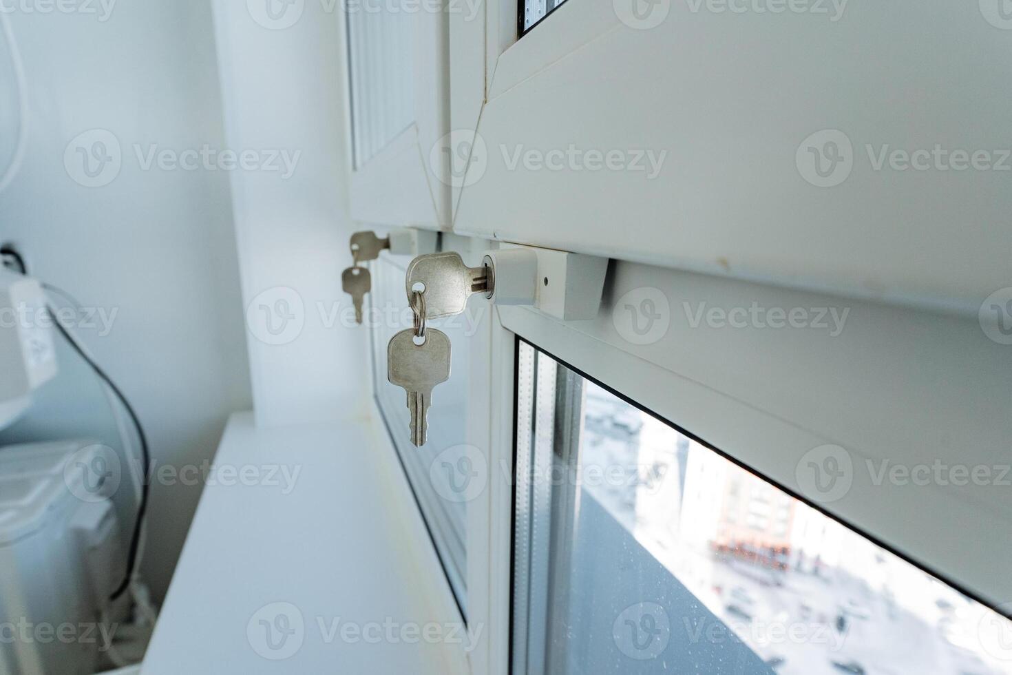 A detailed closeup view of a window that has various keys placed on it, creating an interesting composition and visual appeal, showcasing the interaction of light and shadows photo