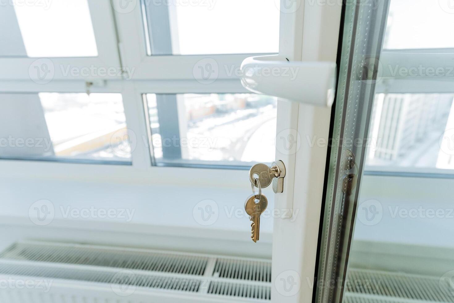 This closeup photograph showcases a beautifully crafted window with a key in the lock, highlighting the exquisite craftsmanship and intricate details of the sash window design photo