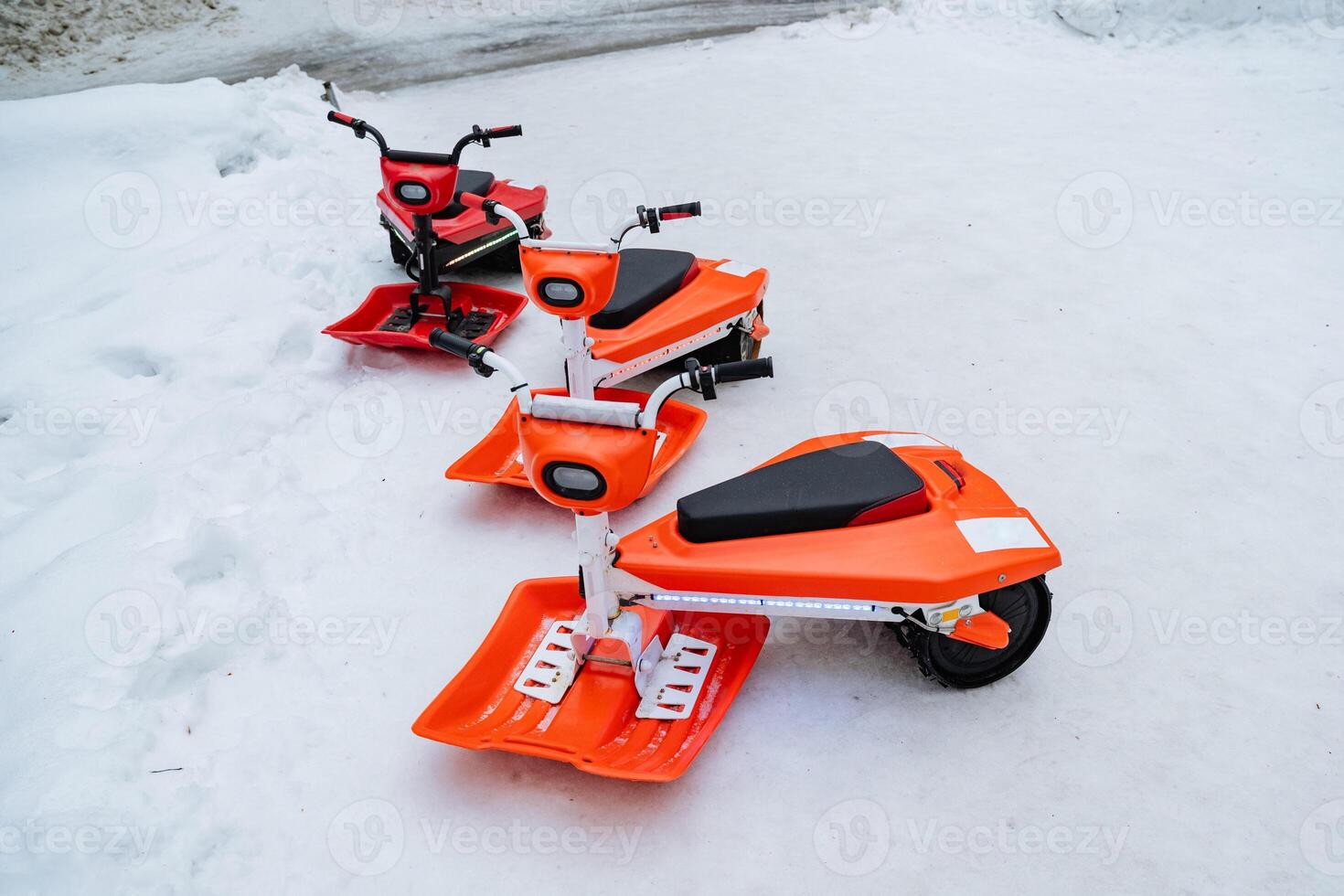 Three powerful snowmobiles are perfectly lined up in the thick, fluffy snow, ready for thrilling adventures and winter exploration in the cold, icy environment of winter sports photo