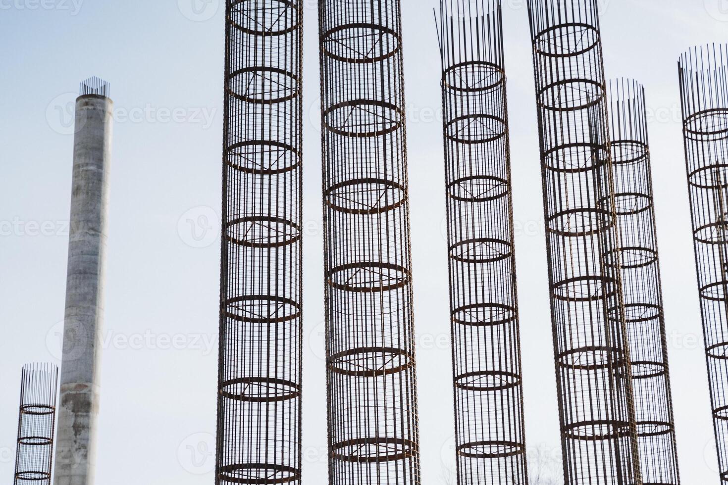 A long row of shiny metal pipes has been perfectly aligned against a stunning vibrant blue sky, creating a striking visual contrast that beautifully catches the eye and captivates attention photo