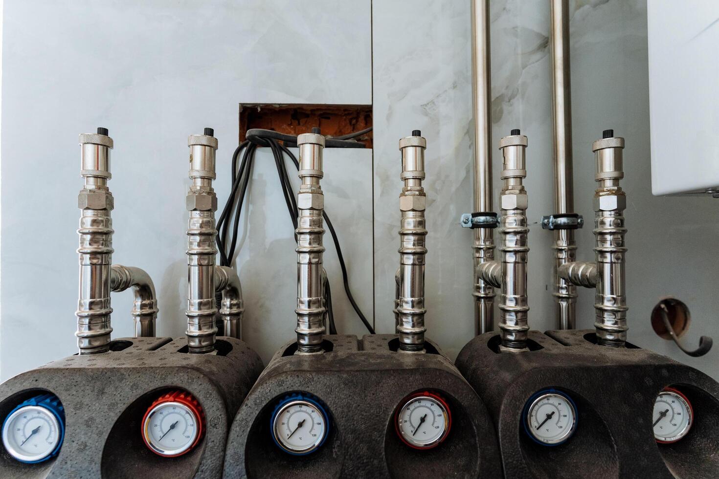 In a spacious industrial room, a wellorganized row of pipes, gauges, and equipment showcases remarkable functionality and operational precision, demonstrating efficiency photo