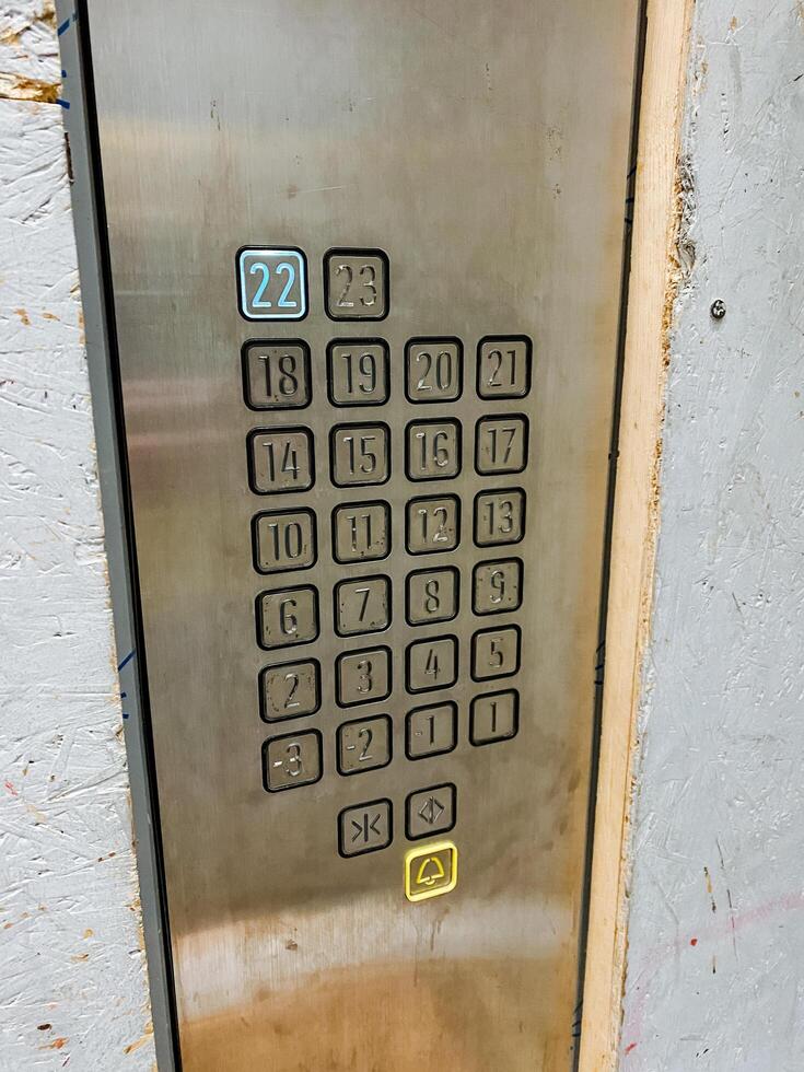 The image features a detailed closeup of an elevator button that prominently displays the number 22 on it, indicating the specific floor it represents in the buildings layout photo