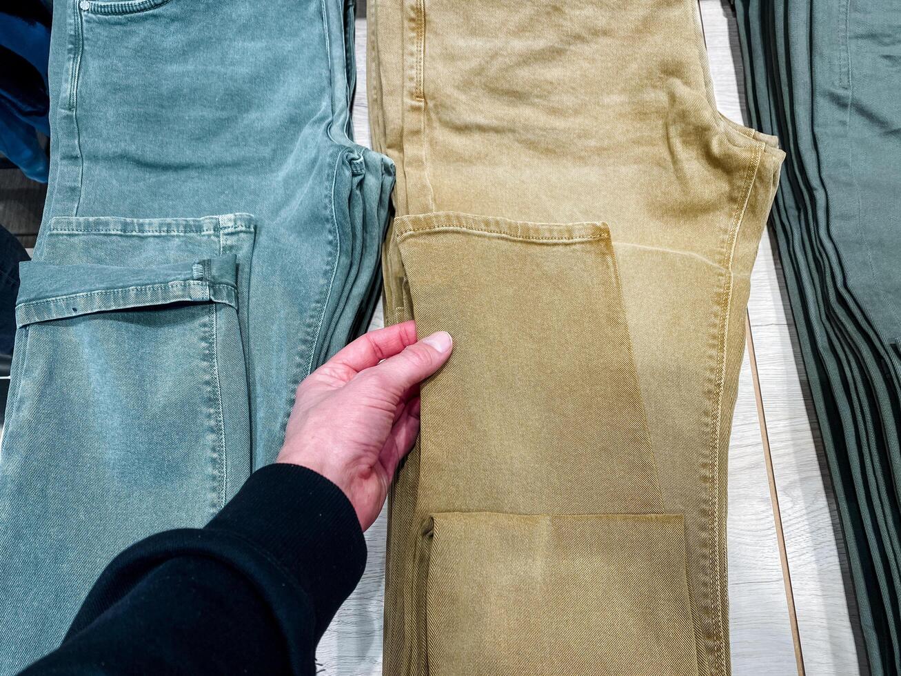 An individual confidently showcases stylish khaki pants that highlight a refined design, trendy color, and highquality fabric that is widely celebrated in the casual wear fashion industry photo