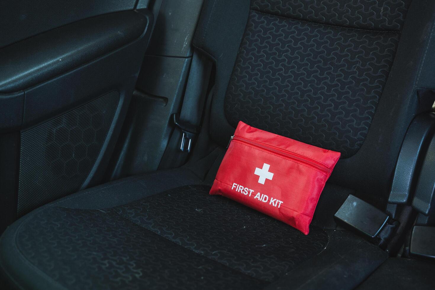 The Compact First Aid Kit conveniently located on the Car Seat serves as essential safety gear designed for various roadside emergencies that may arise during travel photo