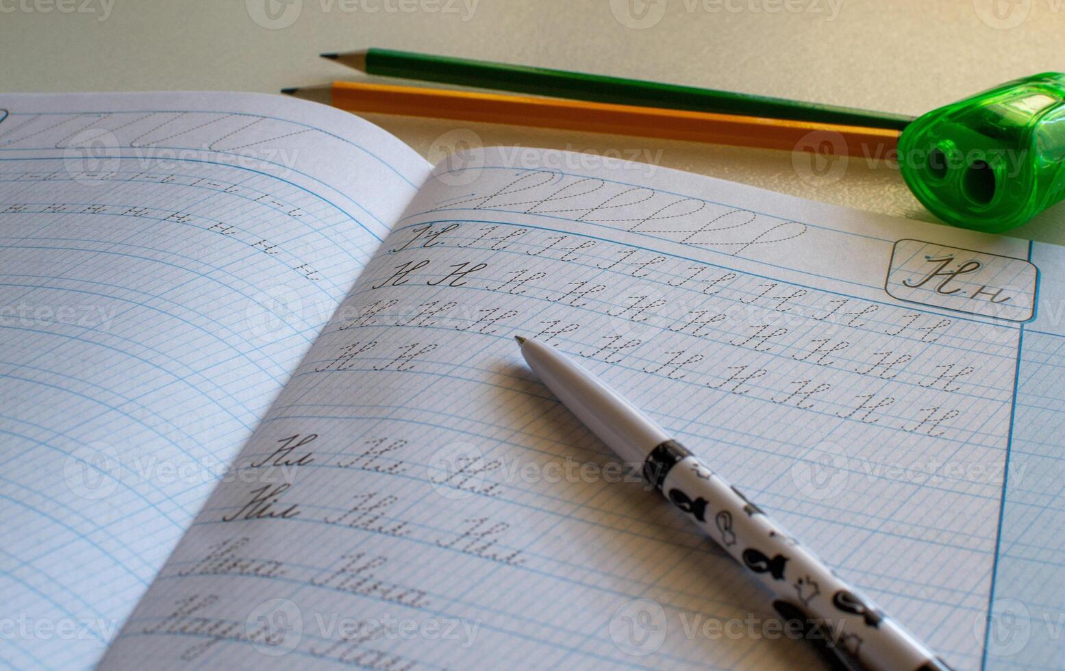 View of pen and pencils on a school notebook, notebook and pencils photo