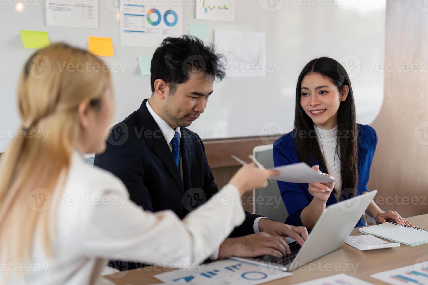 Team of professionals brainstorming in an office, reviewing financial data and strategizing for success. photo
