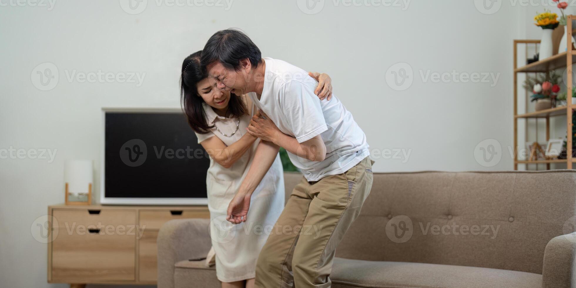 Elderly couple supporting each other during a health scare at home photo
