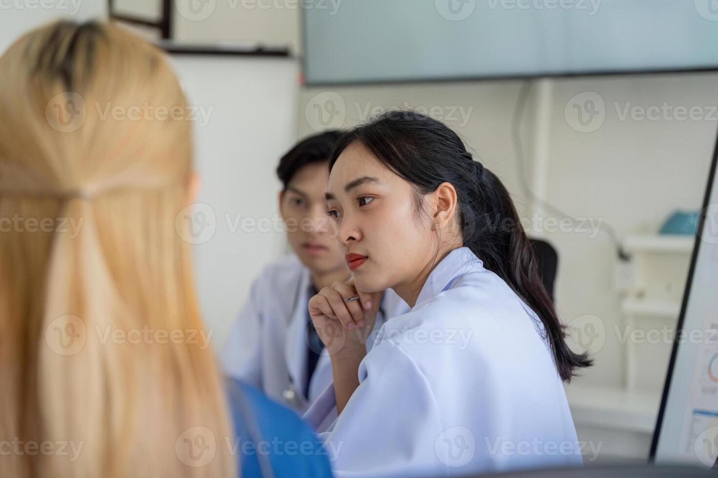 Healthcare professionals engaged in a focused discussion during a meeting. photo