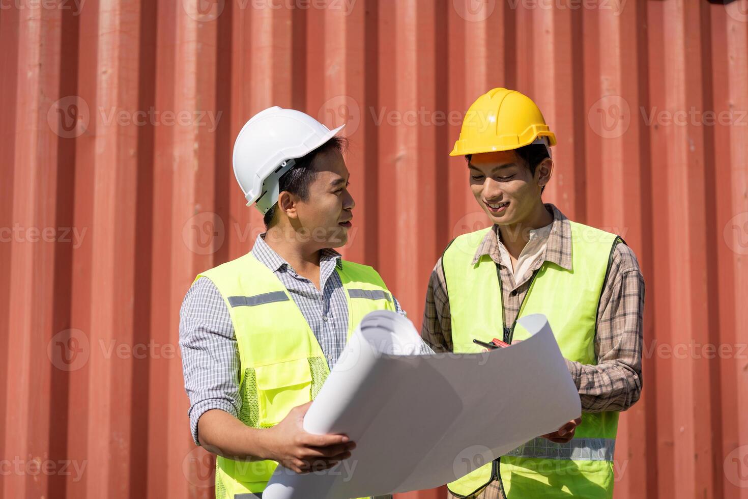 Engineers reviewing construction plans and discussing logistics on-site. photo