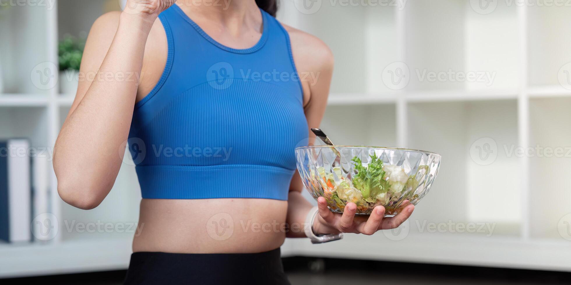 Active woman savoring a nutritious salad, emphasizing healthy habits for weight management. photo