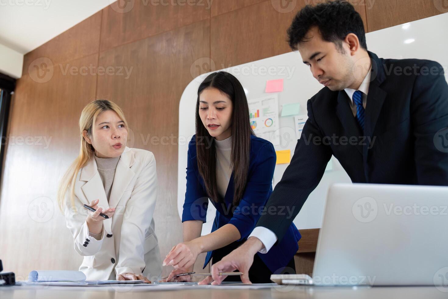 Team of professionals analyzing financial reports and charts during a strategic meeting. photo