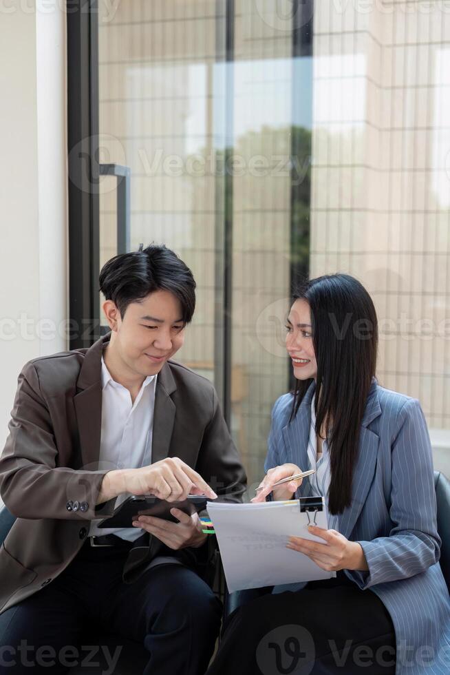 Diverse business team collaborating on project plans and analyzing strategies in a modern office. photo
