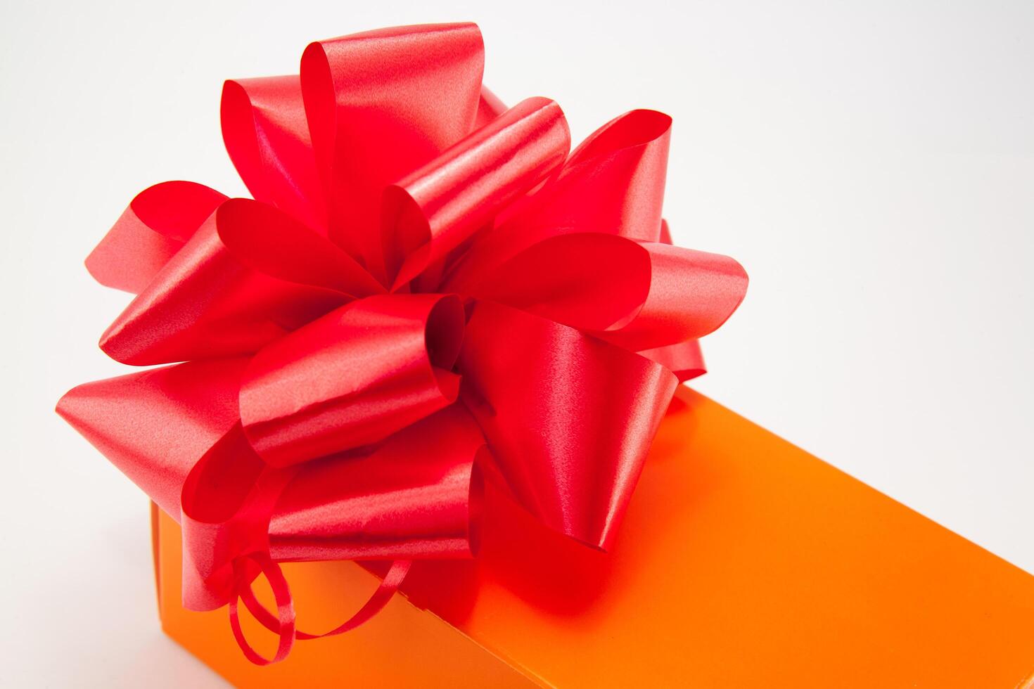 A red gift box with a bow on top photo