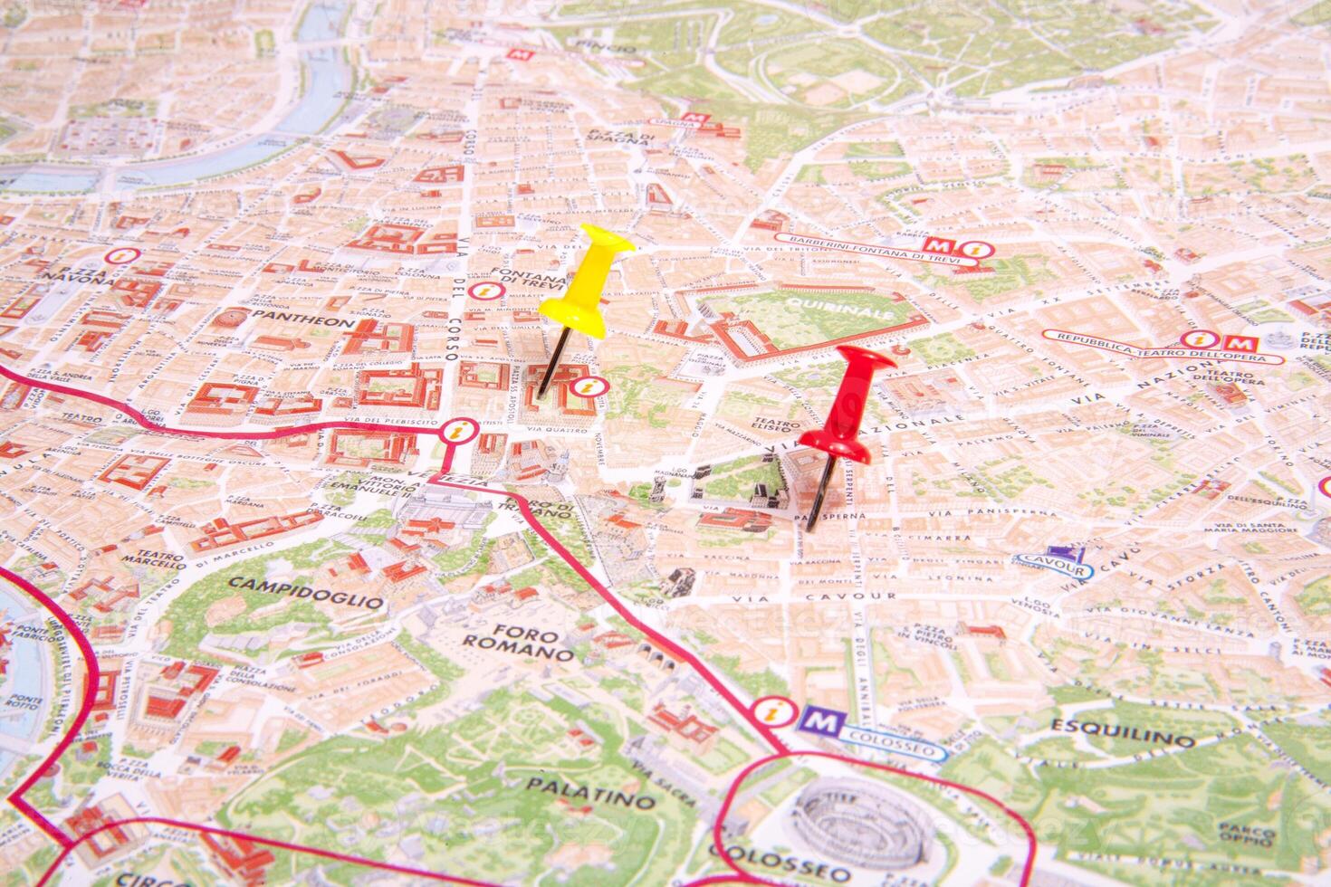 A map with pins pointing to a city photo