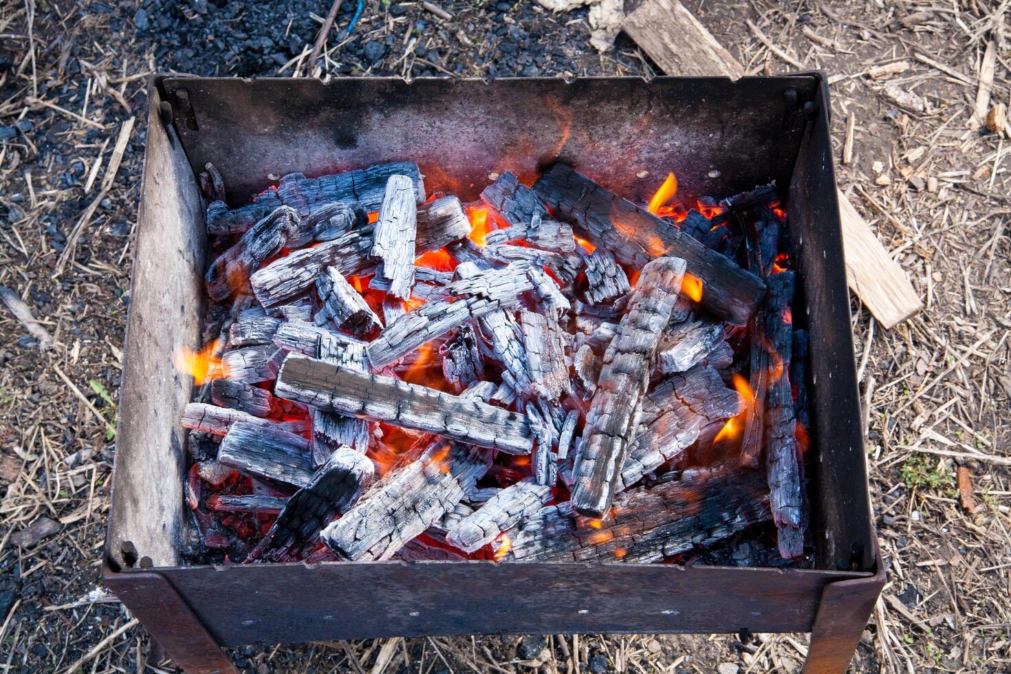 A fire is burning in a metal grill photo