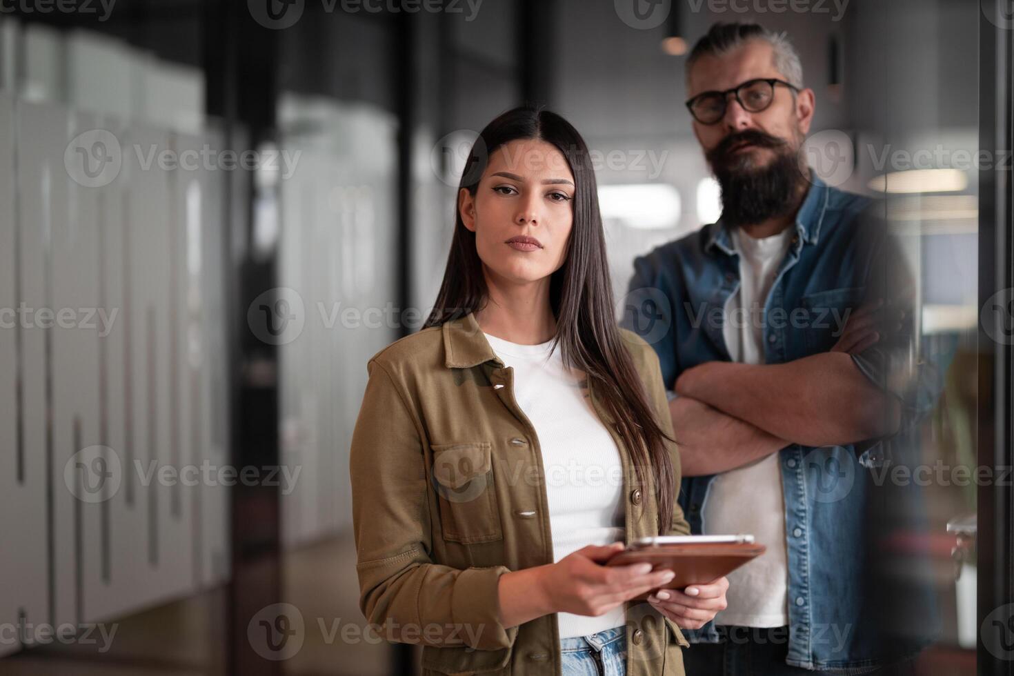 Creative millennials, casual business team, small business owners, working on social media strategy and brand development with a digital tablet in a modern, open space startup office photo