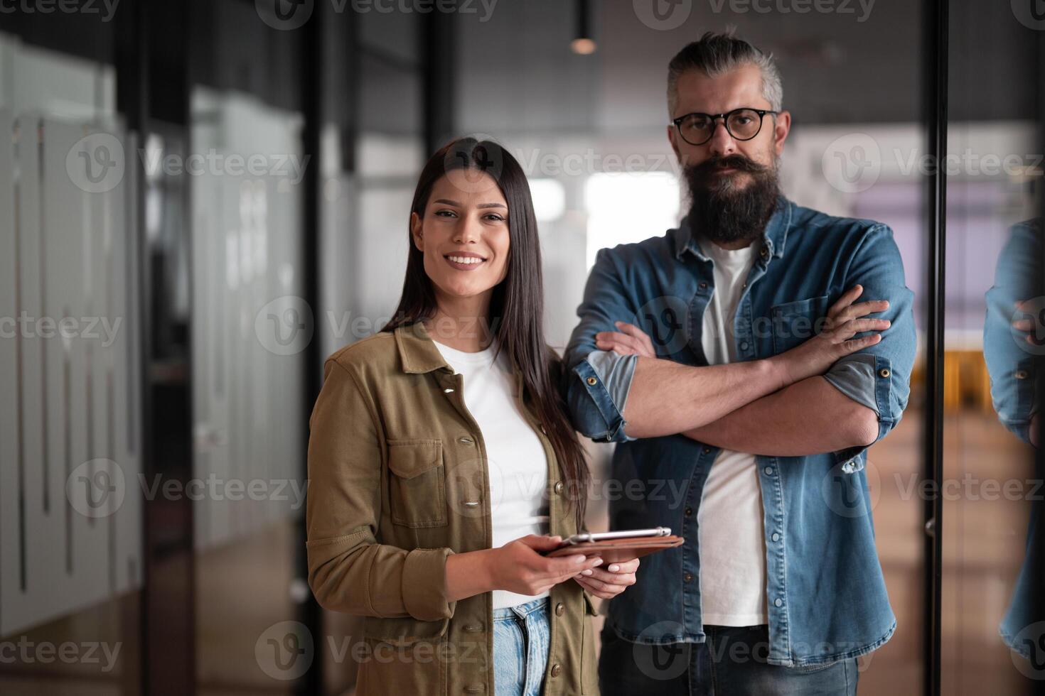 Creative millennials, casual business team, small business owners, working on social media strategy and brand development with a digital tablet in a modern, open space startup office photo