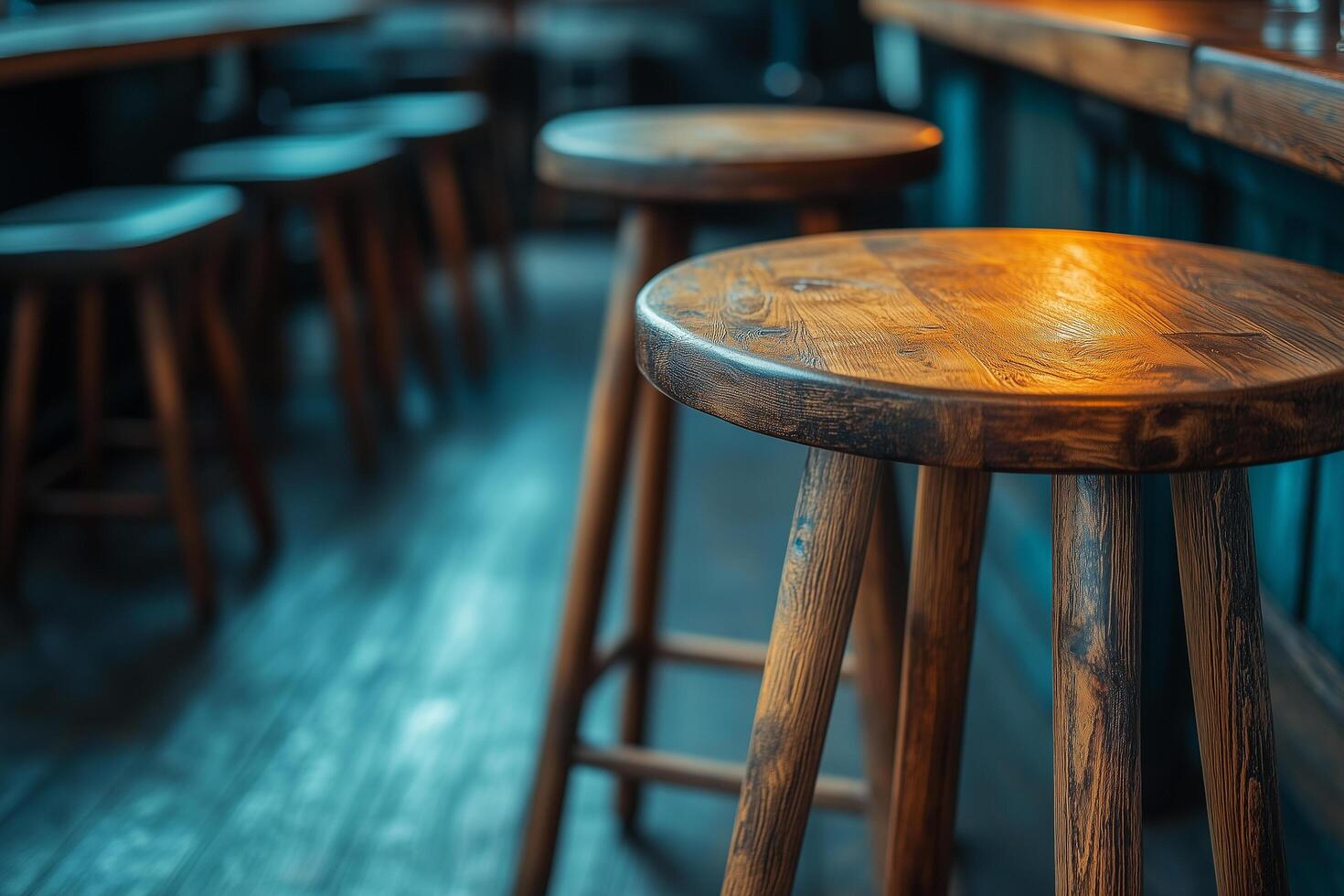 Warm lighting illuminates handcrafted wooden stools in a cozy pub, evoking the spirit of irish american heritage and hospitality photo