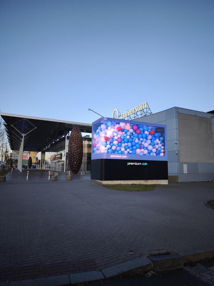 Prague, Czech republic - January 9, 2025 Colorful balloons fill a large glass box, creating a vibrant display outside the O2 universum Conference center Premium OOH 3D billboard photo