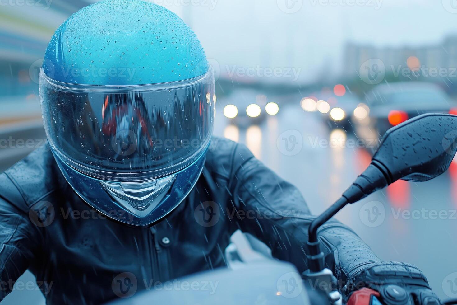 Motorcycle biker with helmet on the road in rainy day. photo