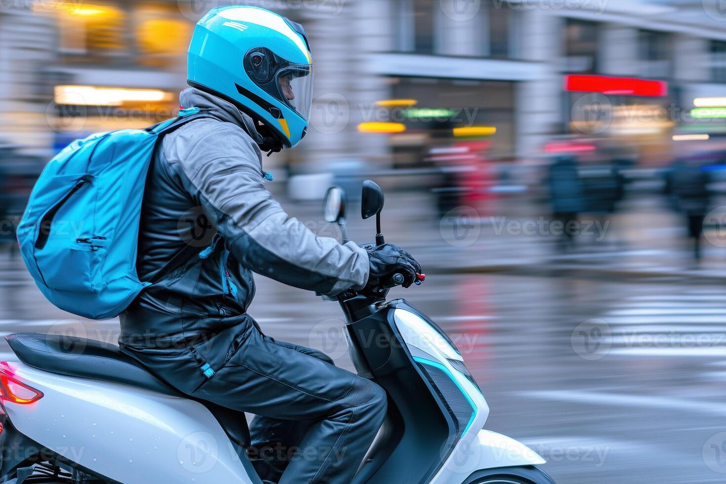 Motorcyclist riding a scooter on a rainy day in the city photo