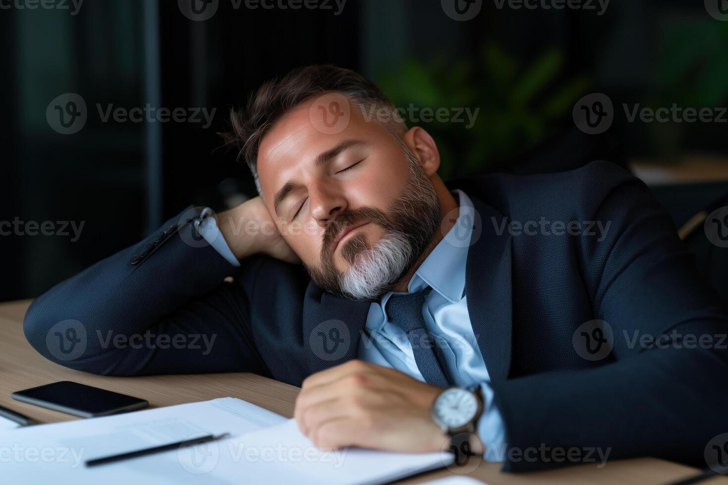 exhausted businessman sleeping at workplace photo