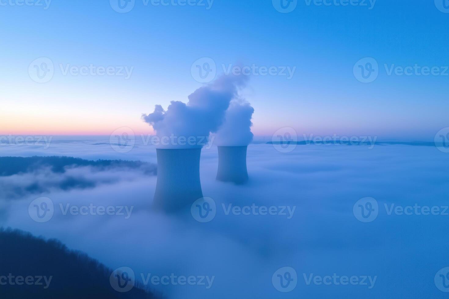 cooling towers of nuclear power plant over the clouds at sunrise photo
