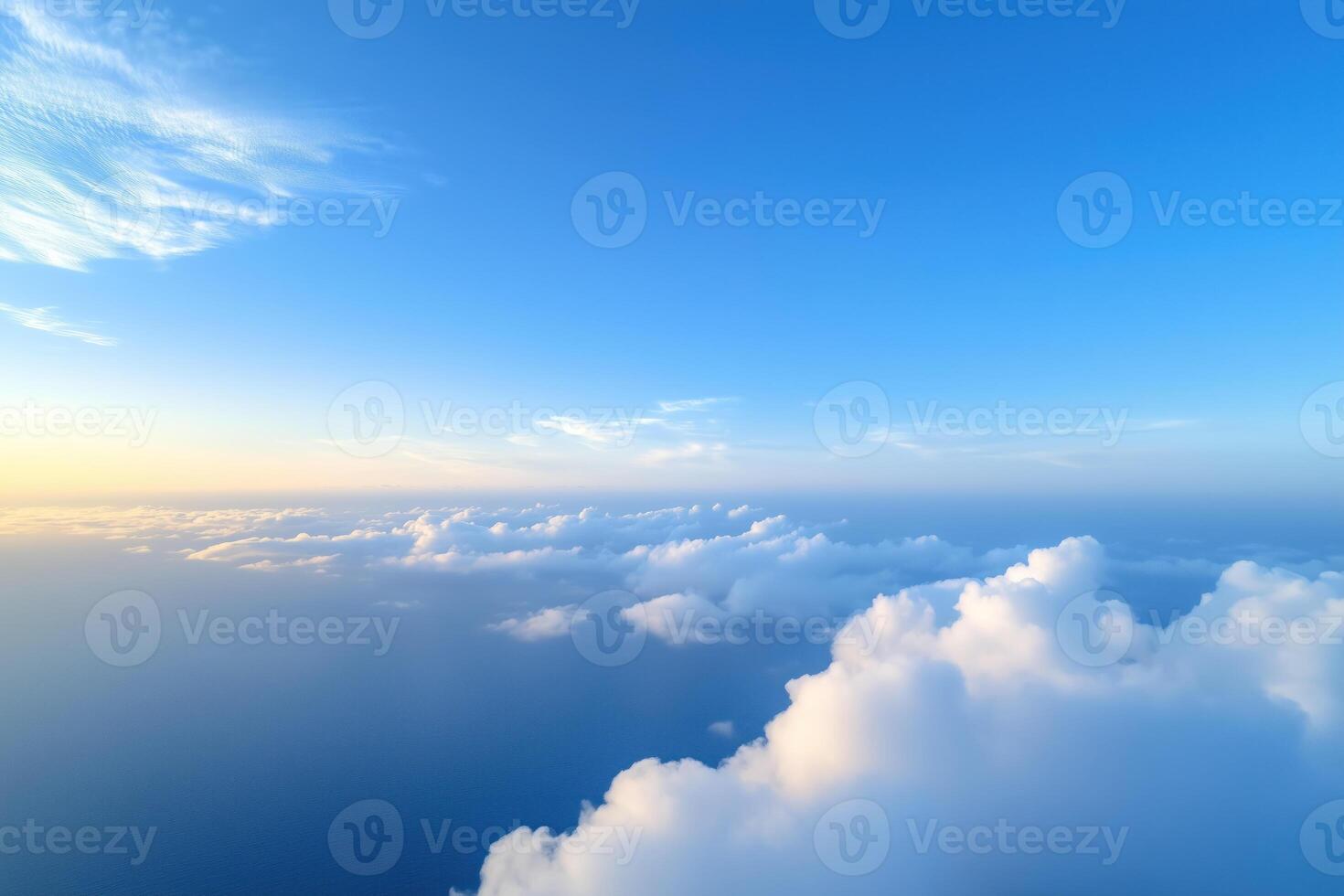 Beautiful aerial view above clouds at sunset. View from airplane window photo