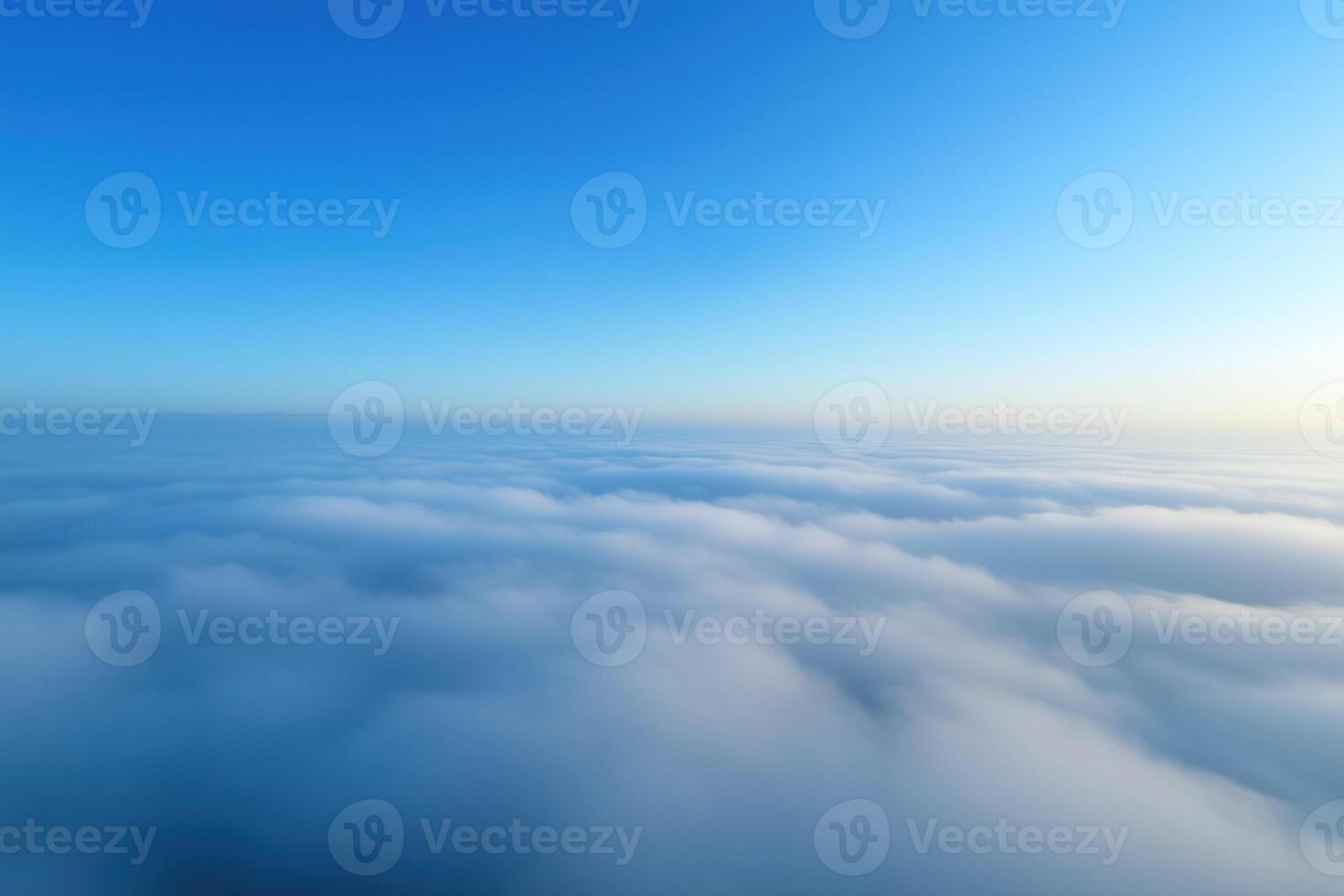 Beautiful aerial view above clouds with blue sky. View from airplane window. photo