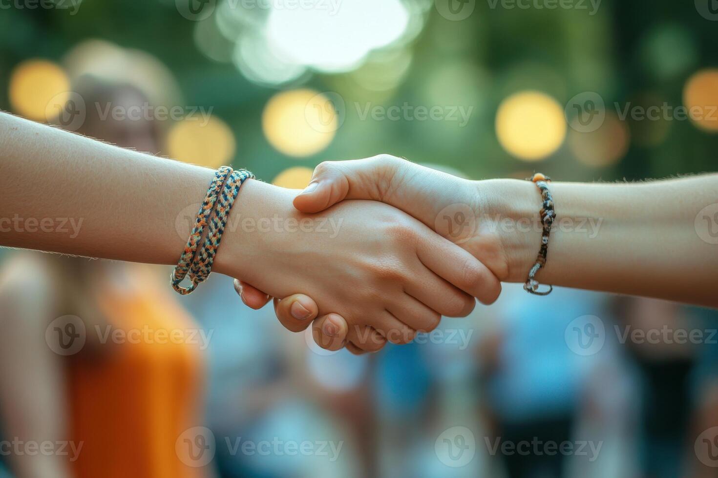 Two People Shaking Hands at a Lively Outdoor Event Capturing Enthusiasm and Connection photo