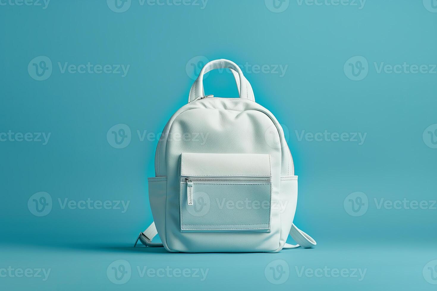 White backpack on a blue background. Back to school concept. Copy space photo