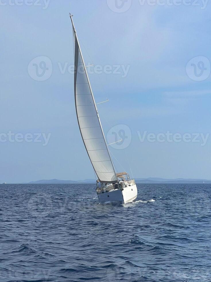 a sailboat sailing in the open ocean photo