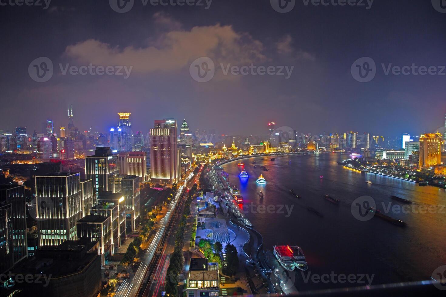 Night view of Shanghai skyline over Huangpu River with colorful reflections c photo