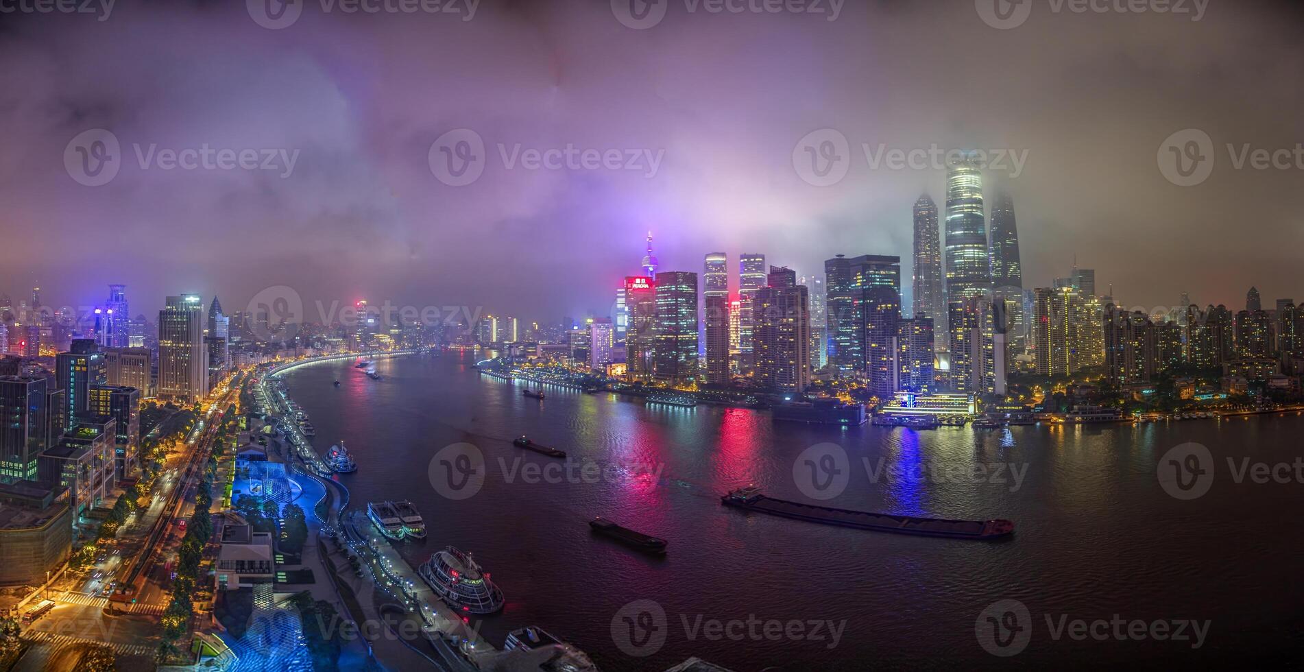 Night view of Shanghai skyline over Huangpu River with colorful reflections b photo