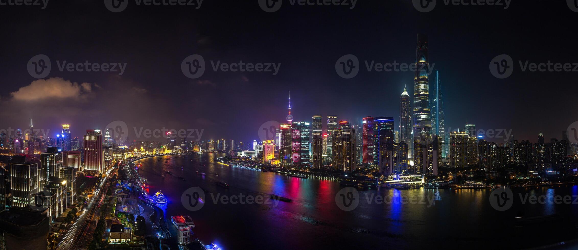 Night view of Shanghai skyline over Huangpu River with colorful reflections f photo