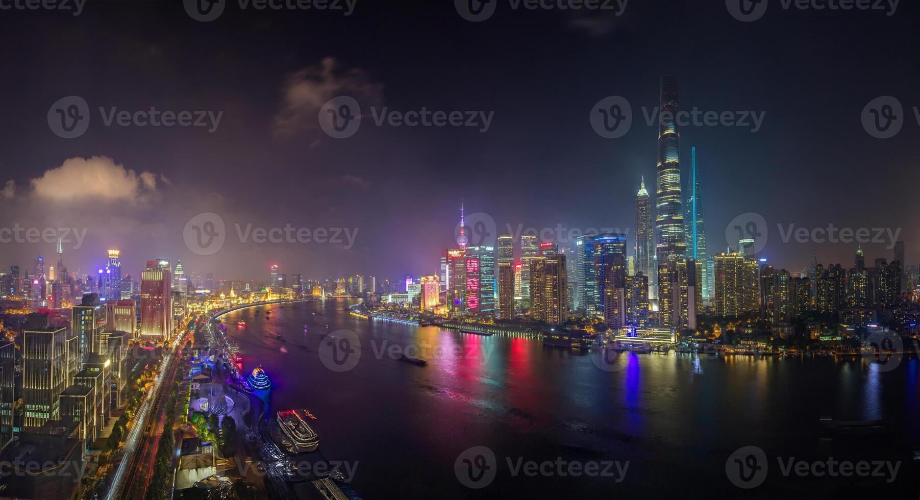Night view of Shanghai skyline over Huangpu River with colorful reflections a photo