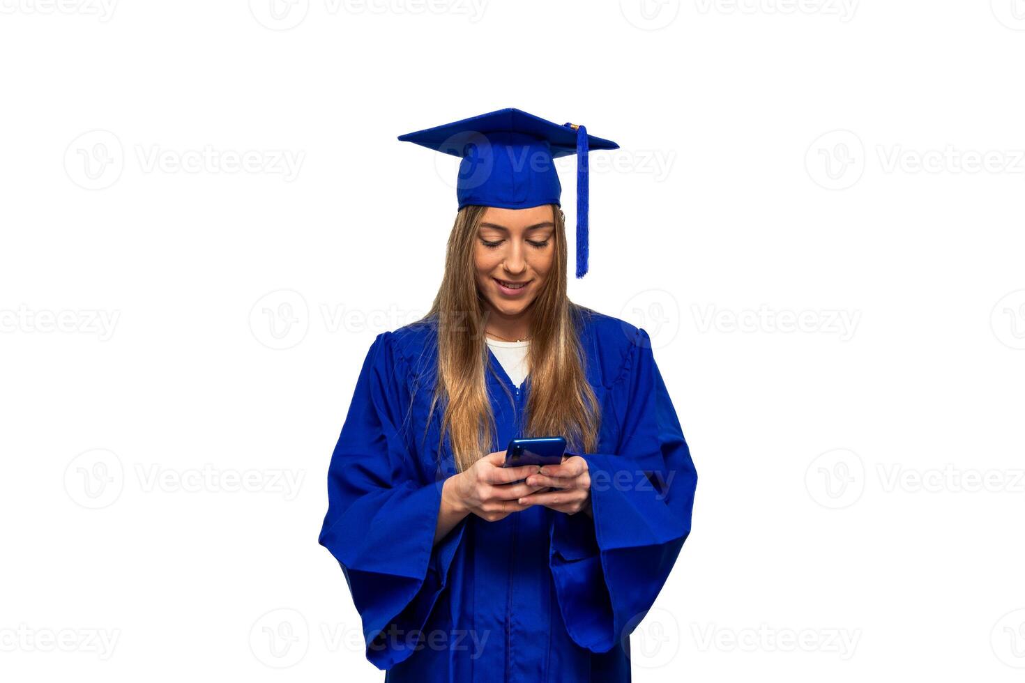 Graduated student wearing blue gown using smartphone on white background photo