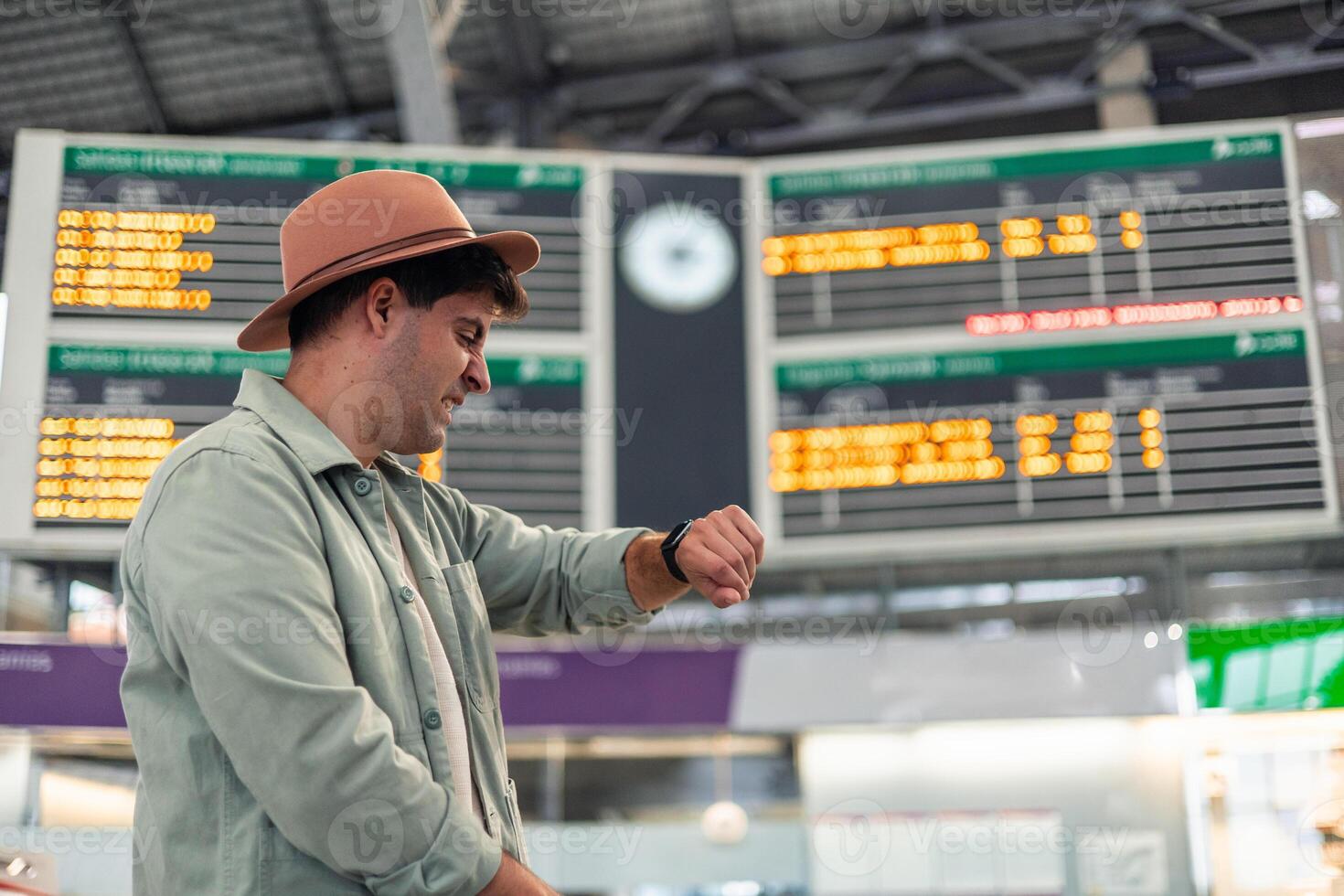latin Tourist checking time on smartwatch while waiting for train departure photo