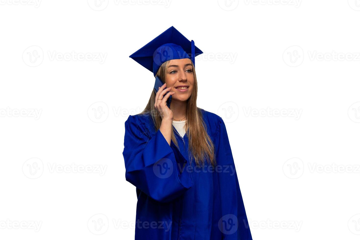 Graduated student wearing blue gown and mortarboard using smartphone on white background photo