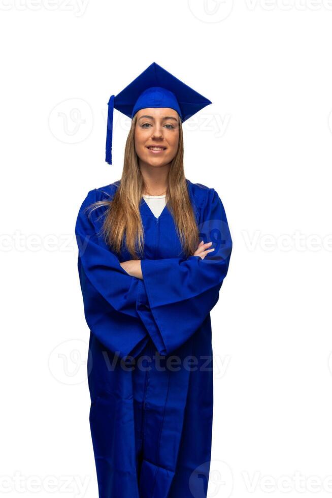 vertical Portrait of graduated college student wearing blue gown and smiling with crossed arms photo