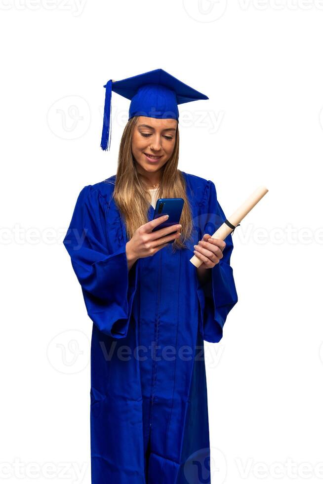 vertical Graduated student using phone and holding diploma, wearing blue gown and smiling photo