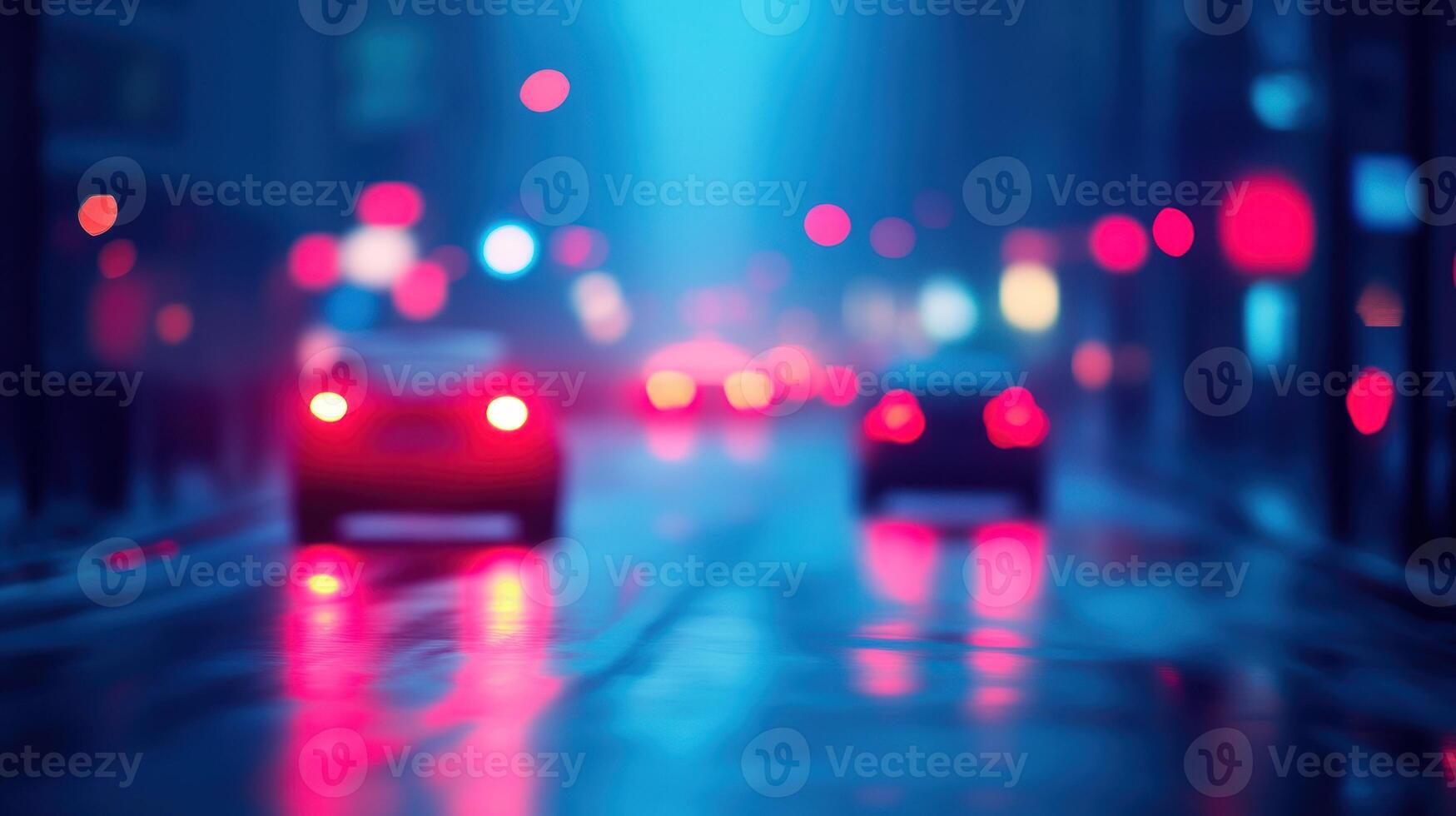 Cars drive through a wet city street illuminated by colorful lights on a rainy night photo