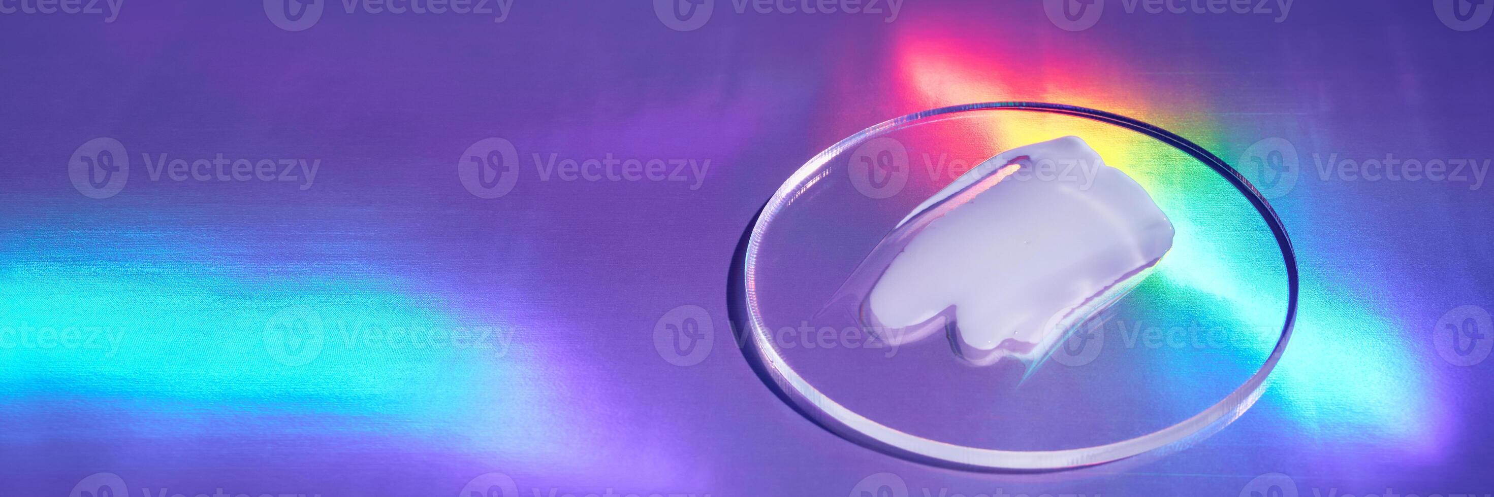 Smear of cream in petri dish on holographic background with iridescent highlights, banner format photo