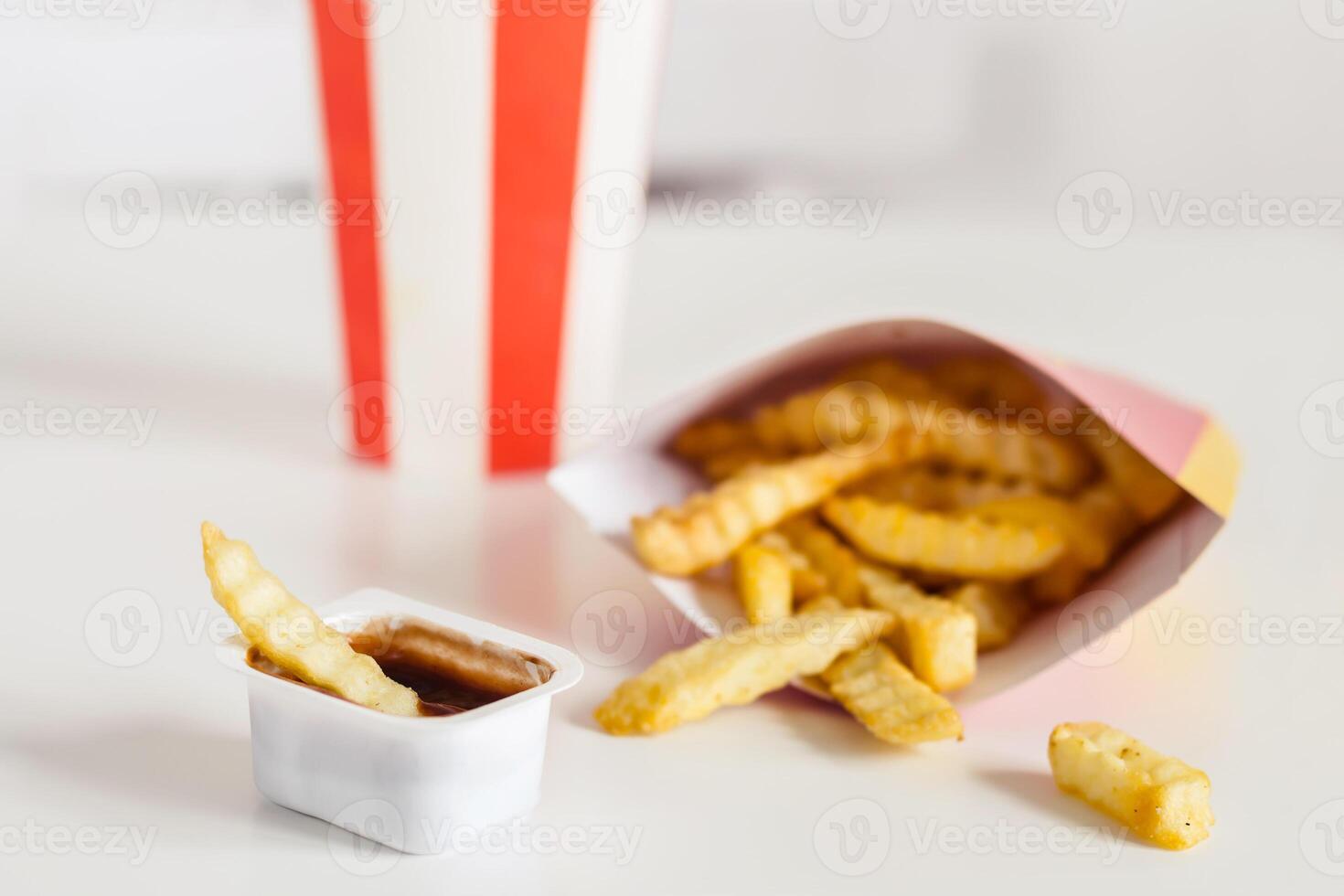 French fries and cola on a white background, selective focus photo