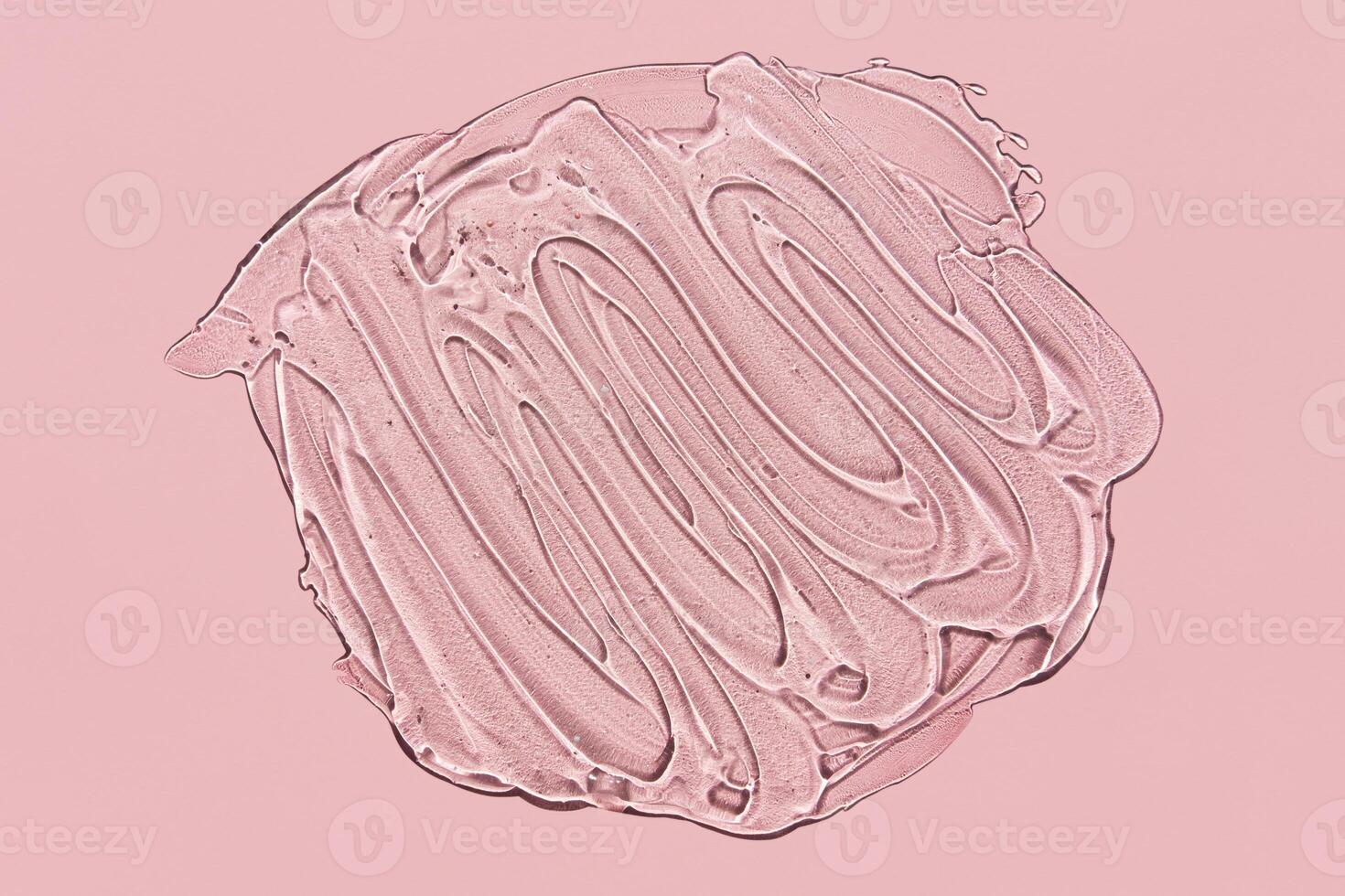 Textured smear of gel with oxygen bubbles on pink background photo