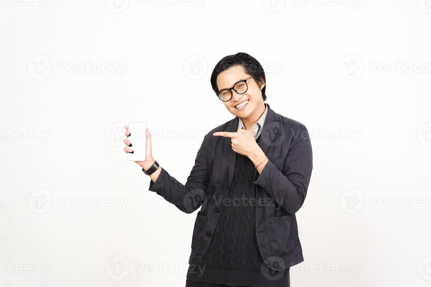 A man in glasses holding a phone and pointing photo